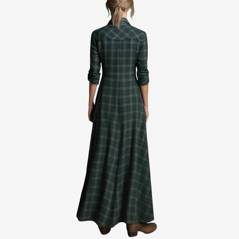Close-up of dark green maxi dress fabric showing smooth drape and sleeve detail