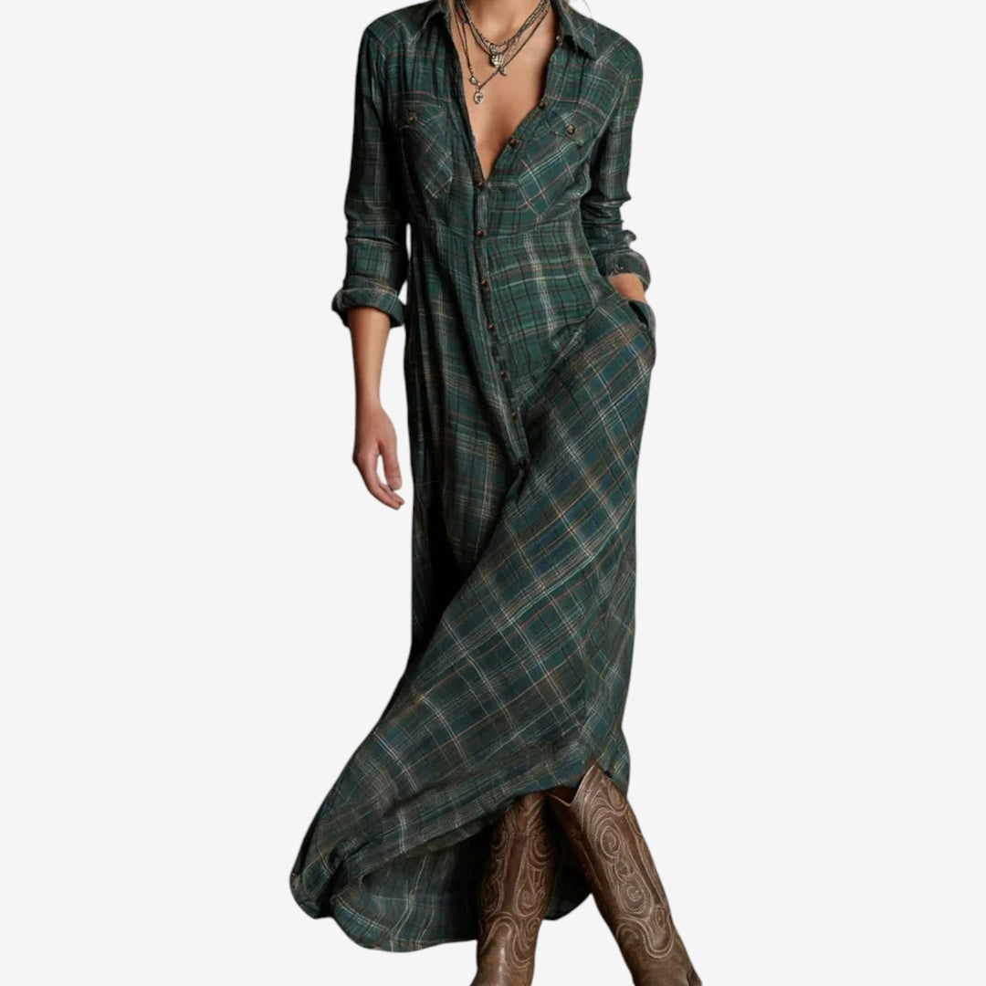 Back view of dark green maxi dress highlighting the flowing hemline and refined cut