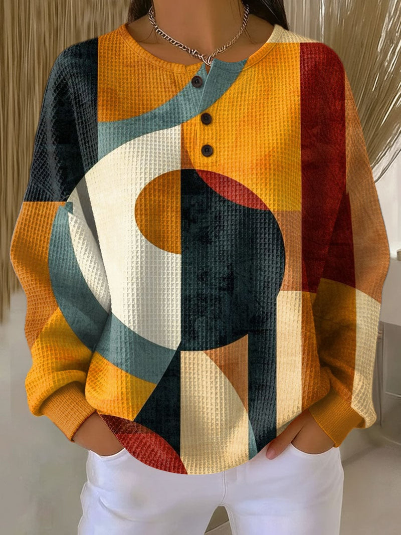 Woman wearing an orange waffle knit sweater with a relaxed, flattering silhouette