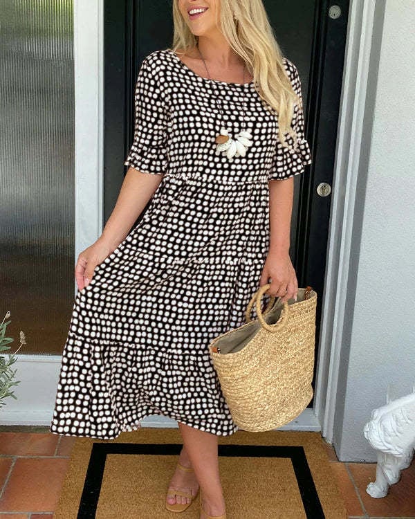 Close-up of the scattered dot print detail on a relaxed midi dress