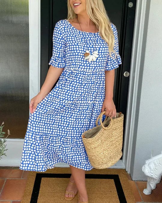 Side view of the tiered midi dress highlighting the relaxed, flowing fit