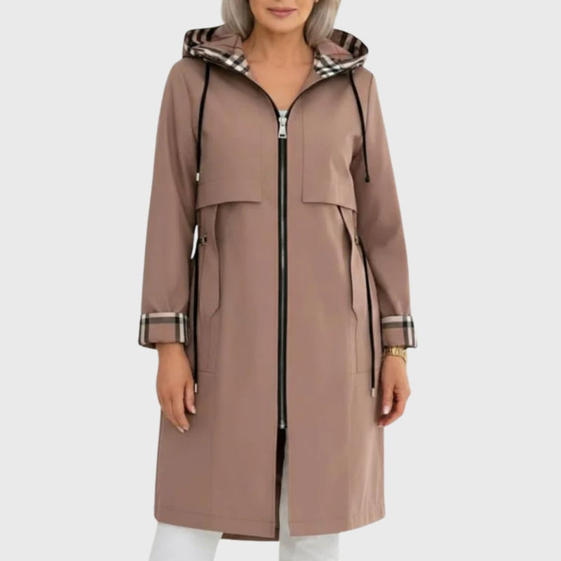 Woman wearing the Mika lightweight trench coat in brown, featuring a tailored silhouette and adjustable belt