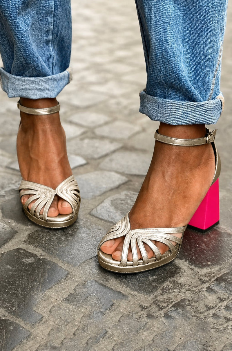 Gold ankle strap block heel sandal styled view showing full silhouette and heel detail