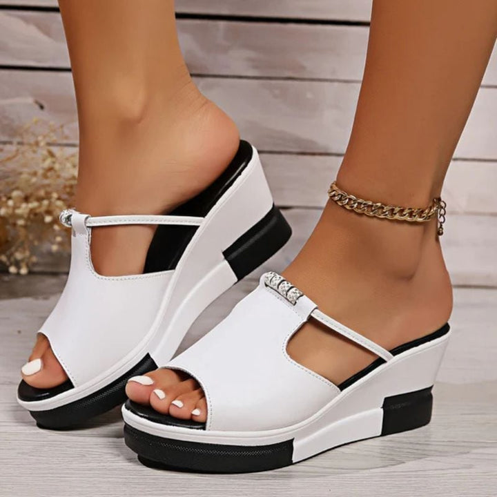 Minerva platform T-bar sandals in black, side profile highlighting elevated platform height