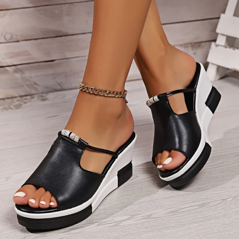 Minerva platform T-bar sandals in black, close-up of T-bar strap and toe box detail