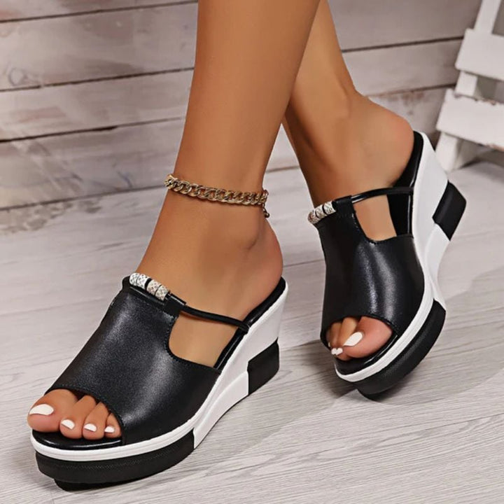 Minerva platform T-bar sandals in black, close-up of T-bar strap and toe box detail