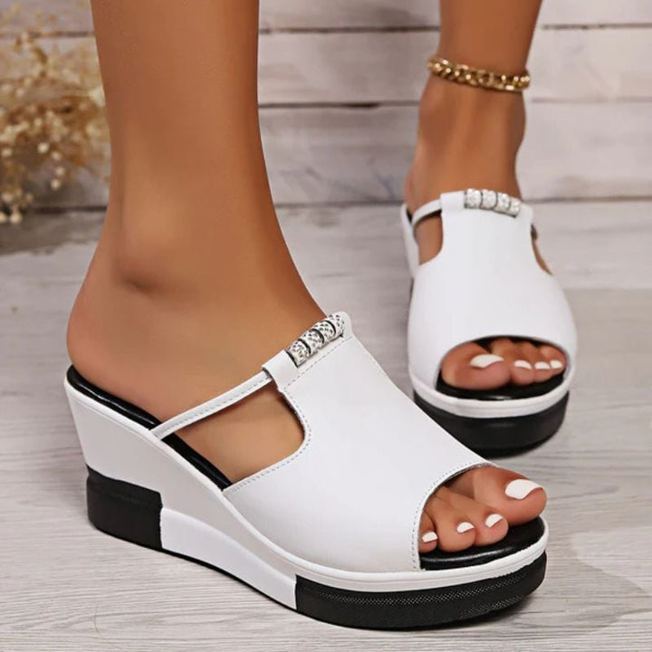 Minerva platform T-bar sandals in white, side profile highlighting platform sole and strap design