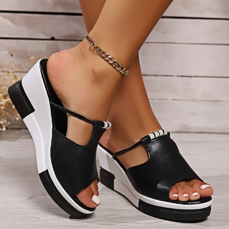 Minerva platform T-bar sandals in white, close-up of T-bar strap detail and slip-on construction