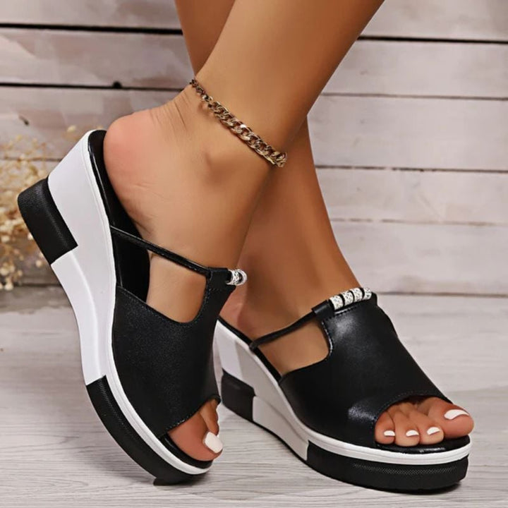 Minerva platform T-bar sandals in white, close-up of T-bar strap detail and slip-on construction