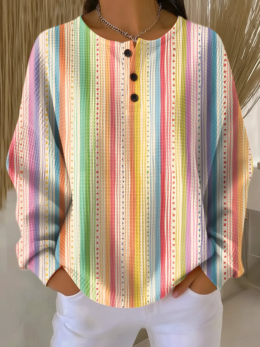 Woman wearing the Mira chic simple blouse in a multicolored lightweight fabric with a clean, flattering silhouette