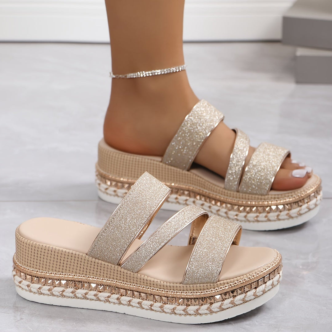 Side profile view of the Mira beige women's flat sandals highlighting the delicate strap detail