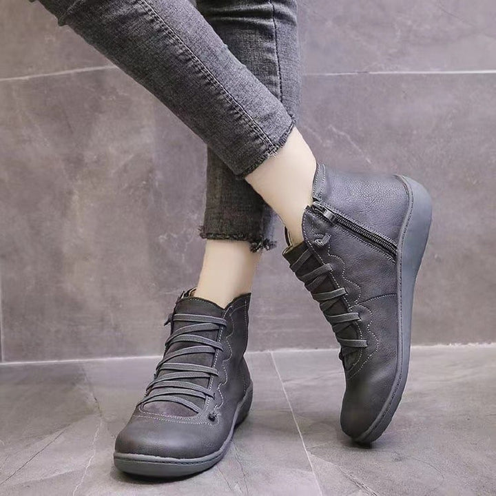 Pair of women's brown support boots shown side by side