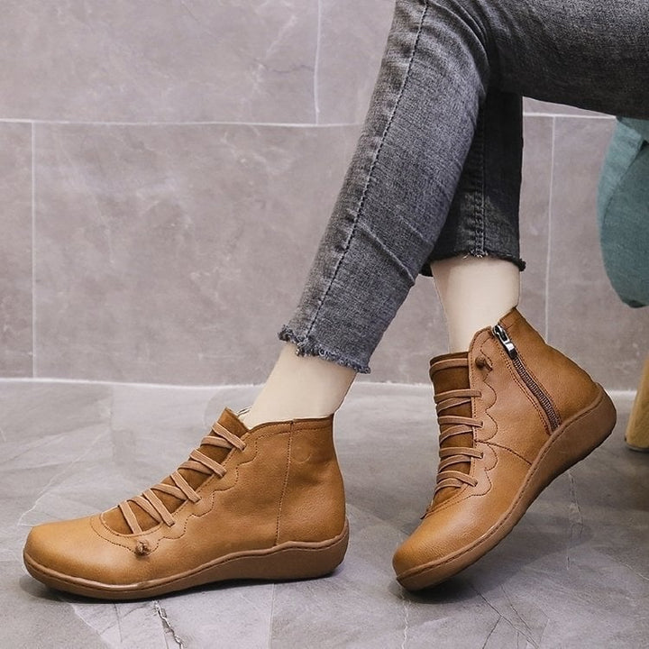 Women's support boot in black shown from heel angle