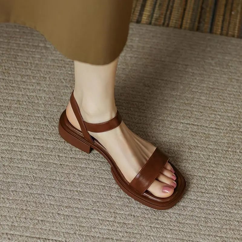 Overhead flat lay of Molly vegan leather sandals in all three color options: black, brown, and white