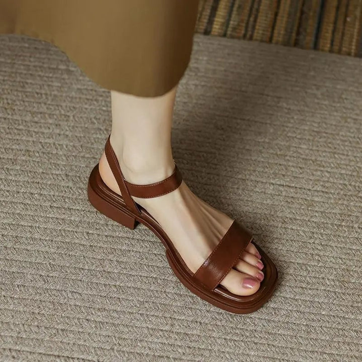 Overhead flat lay of Molly vegan leather sandals in all three color options: black, brown, and white
