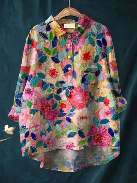 Model wearing floral blouse tucked into tailored trousers with heels