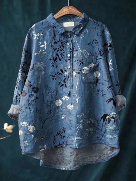 Model wearing floral blouse in a relaxed outdoor setting, movement shot