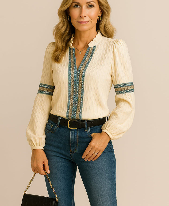 Woman styling a black V-neck blouse with tailored trousers for a polished look