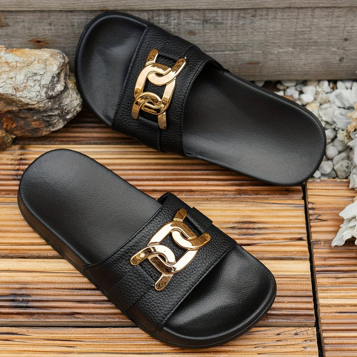 Monroe women's black sandal styled with a flowing midi dress on a light background