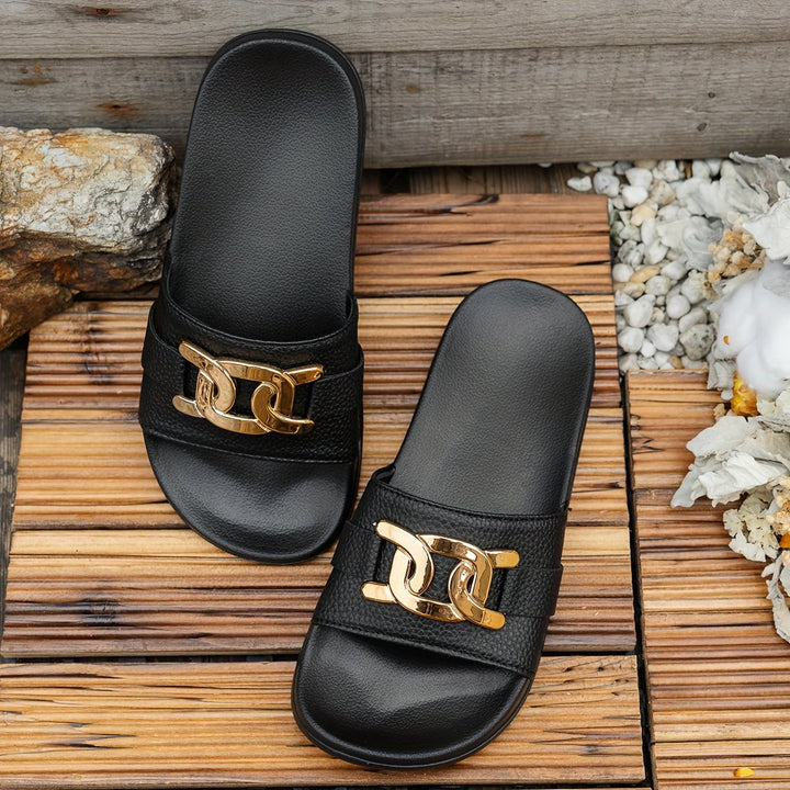 Pair of Monroe black sandals laid flat side by side on a neutral surface