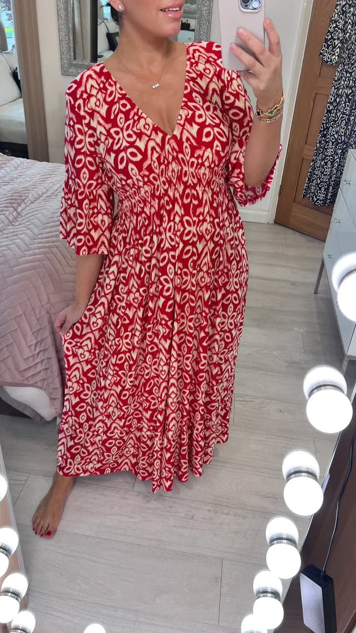 Woman wearing the Monroe flowy long evening dress in red, showcasing the full-length silhouette and elegant drape