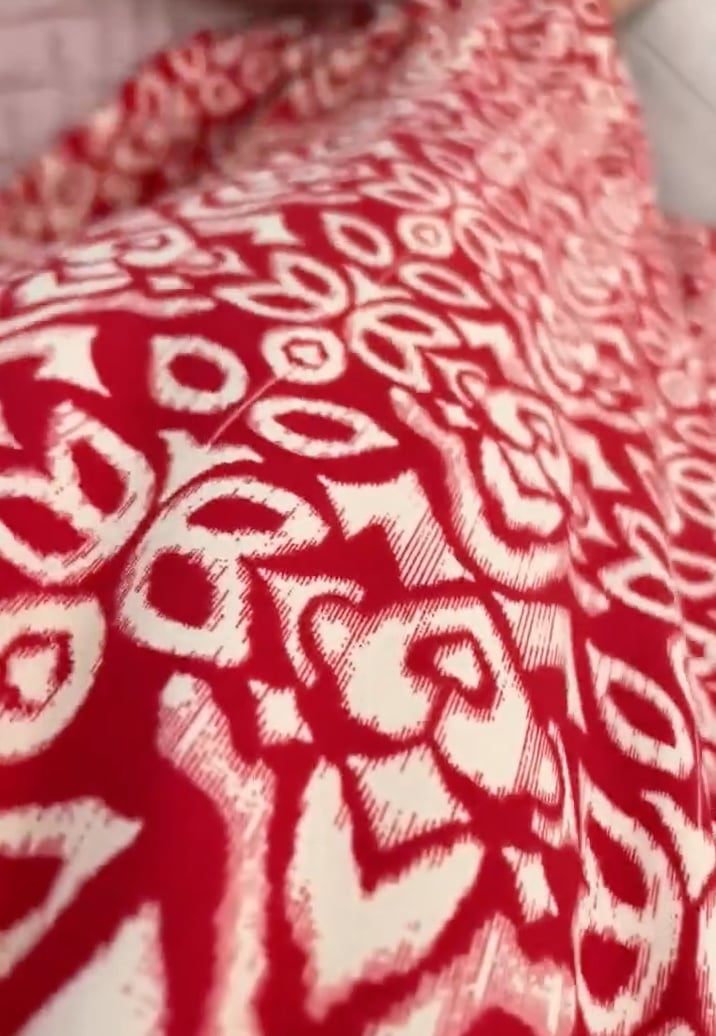 Close-up detail of the Monroe evening dress fabric and hem, emphasizing the soft drape and refined finish