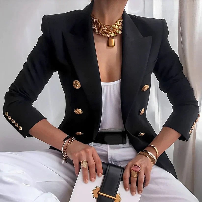 Woman wearing the Monroe classic double-breasted blazer in black with gold-tone buttons and structured shoulders