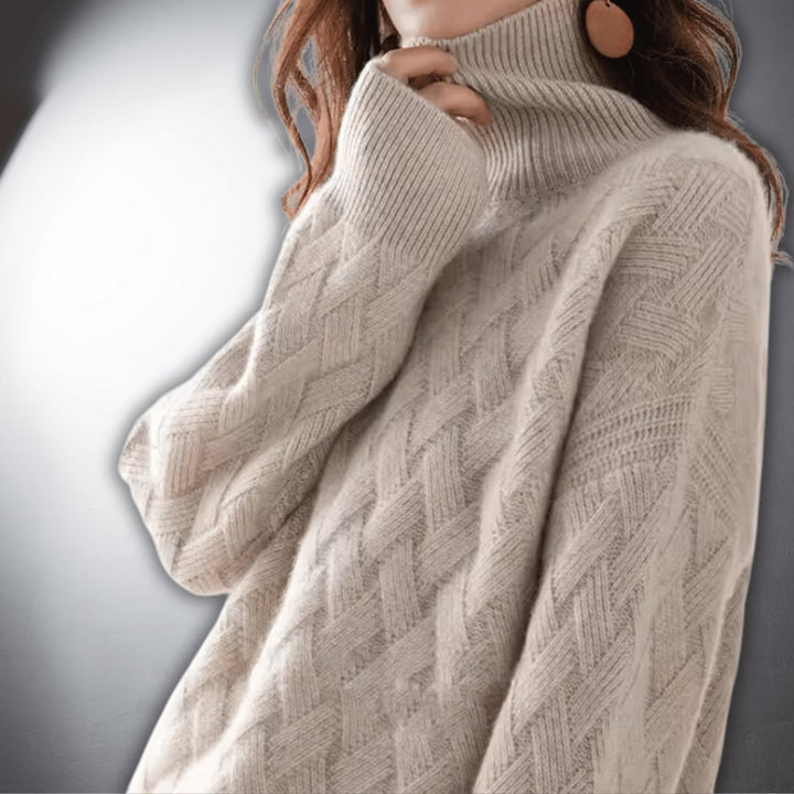Close-up of an off white oversized sweater showing soft fabric texture and relaxed silhouette