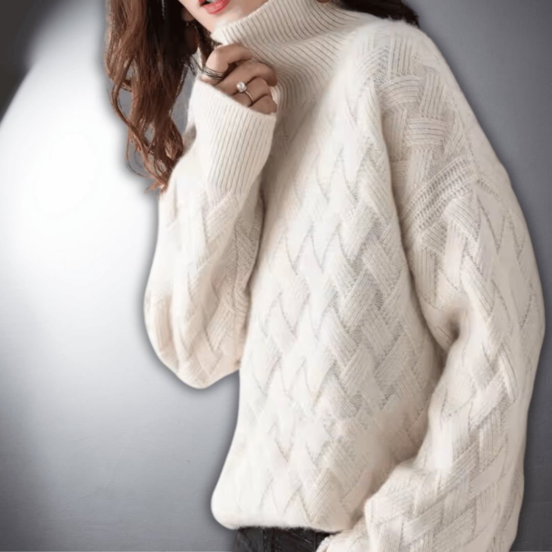 Lifestyle flat lay of an oversized sweater in off white on a neutral background