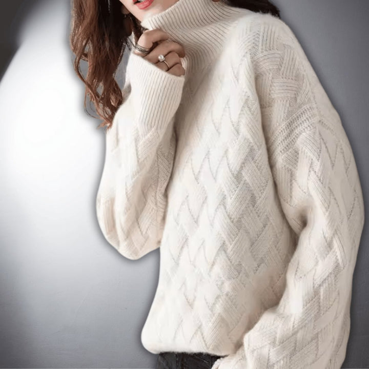 Lifestyle flat lay of an oversized sweater in off white on a neutral background