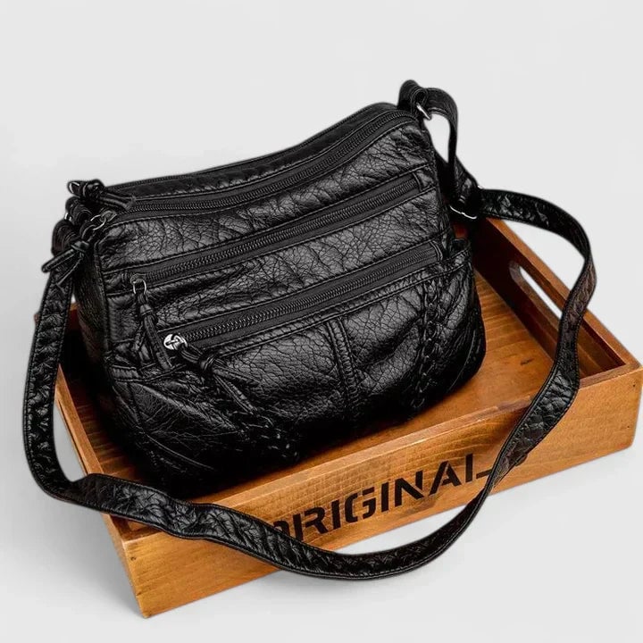 Black version of the Mykahlynn elegant structured handbag shown from the front on a minimalist background