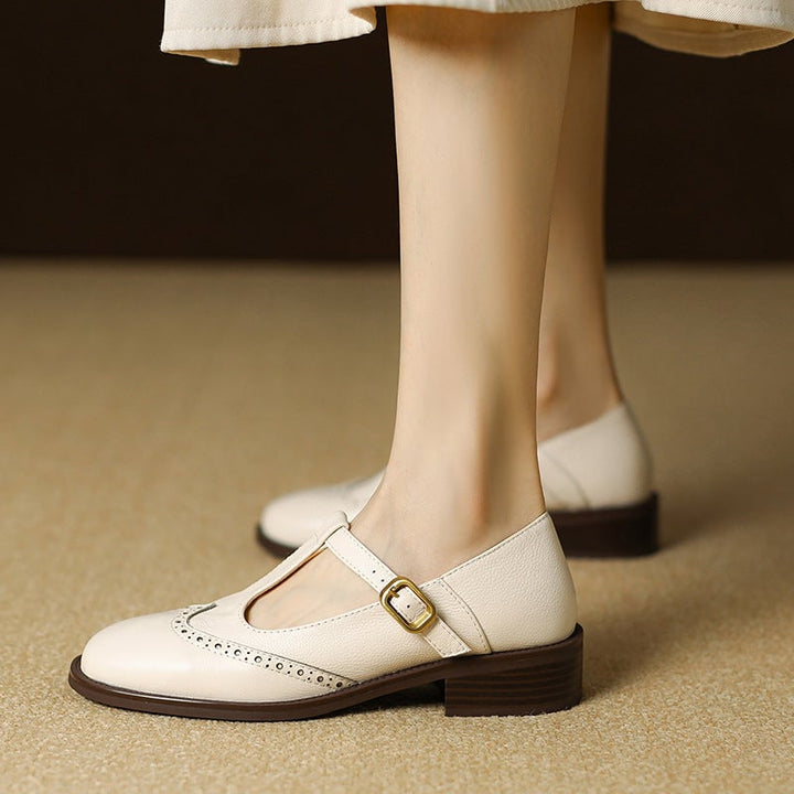 Nadine beige leather T-strap Mary Jane shoes with low block heel and brogue wingtip detail, front view