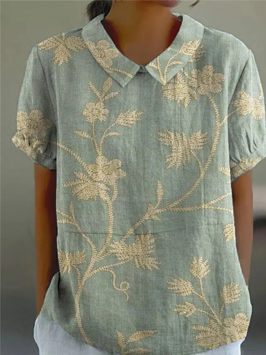 Woman wearing a relaxed-fit floral shirt in a light floral print, styled casually for a daytime look