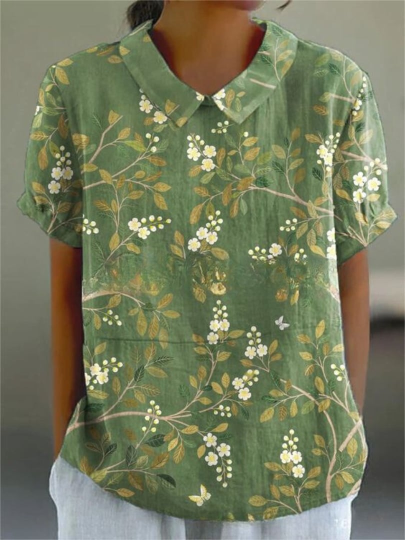 Model wearing the Nancy floral shirt in light pink floral print, paired with casual bottoms