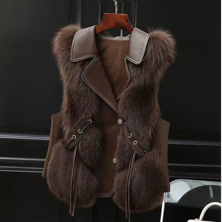 Model wearing the Natalie plush faux fur vest in beige over a white blouse, front view