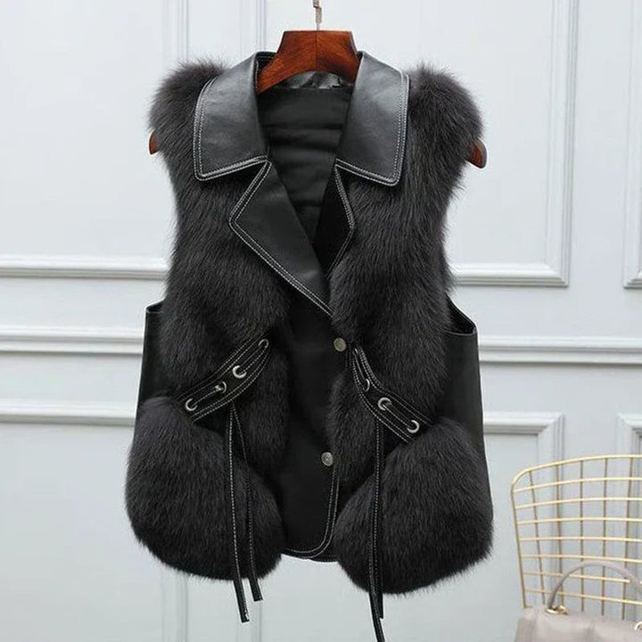Model wearing the Natalie faux fur vest in black styled with jeans, side view