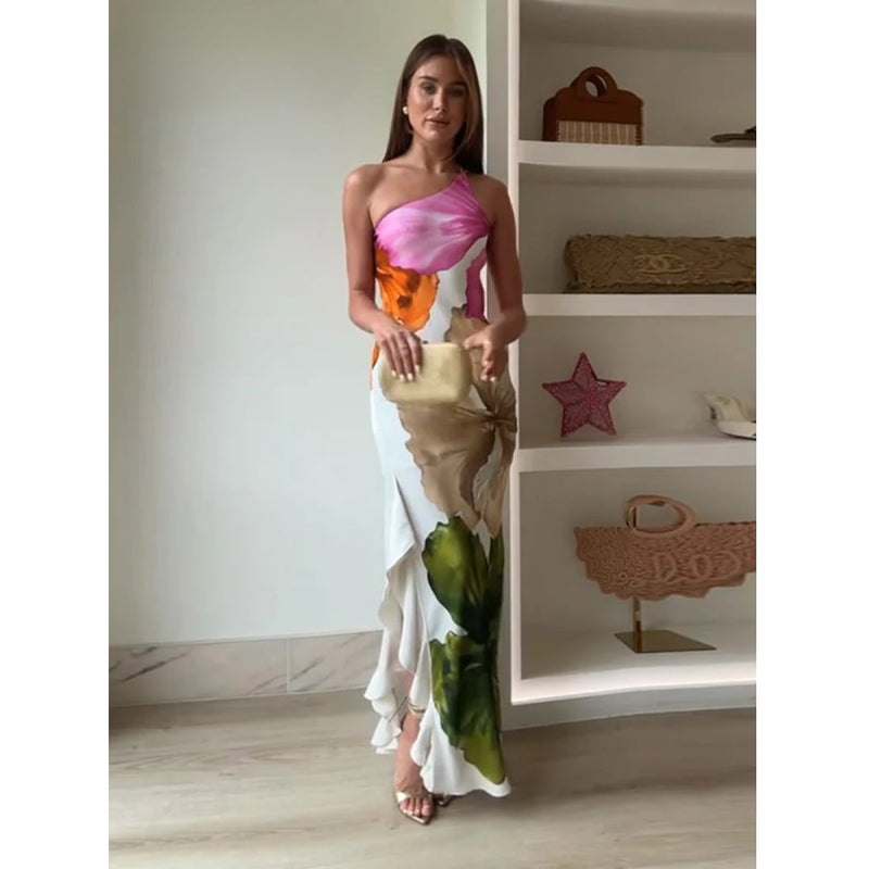 Side view of the Natasha one shoulder floral maxi dress highlighting the fitted waist and flowy hem