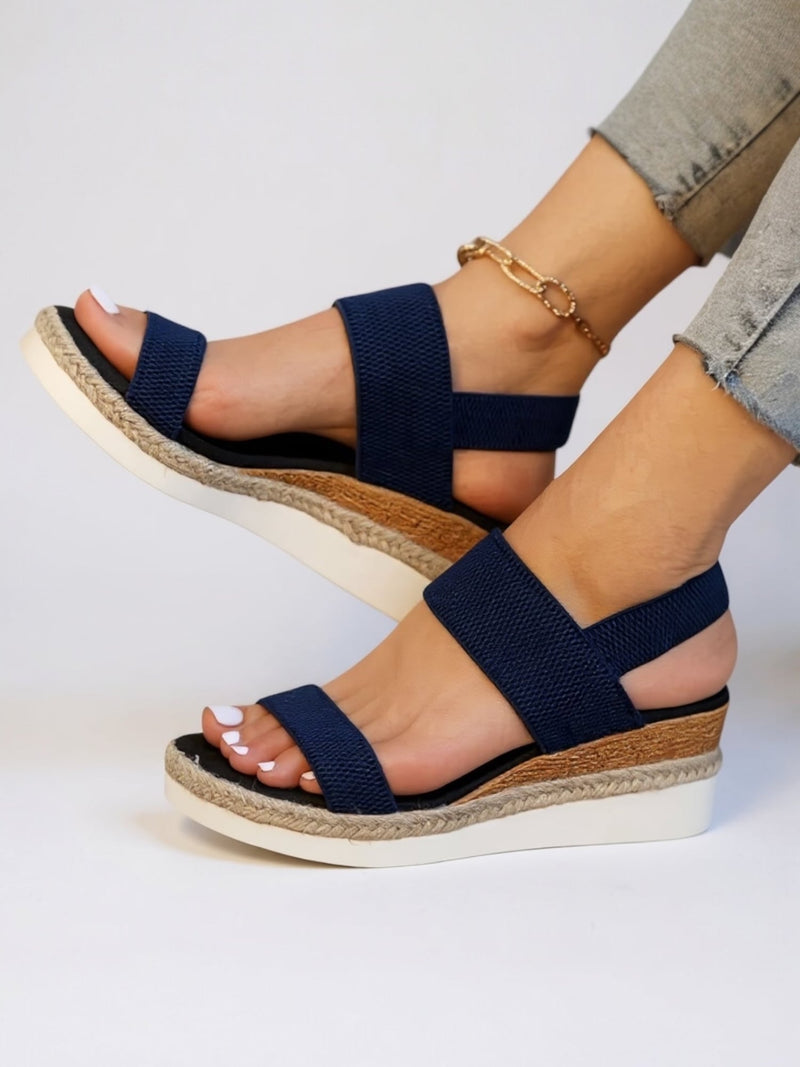 Neve platform sandals in pink shown from a three-quarter angle highlighting the elevated sole