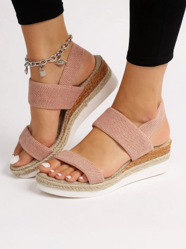 Side profile of Neve platform sandals in black showing the gently elevated platform sole height