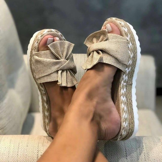 Nina woven wedge sandals in beige with bow accent detail, side view