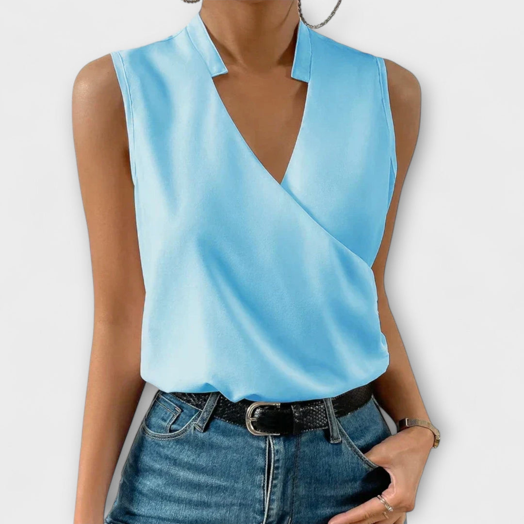 Close-up of the collared V-neckline and crossover wrap front on the Nina blouse