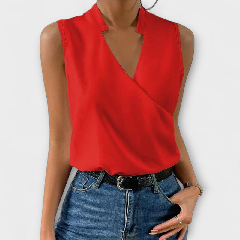Back view of the Nina sleeveless wrap collared blouse in black