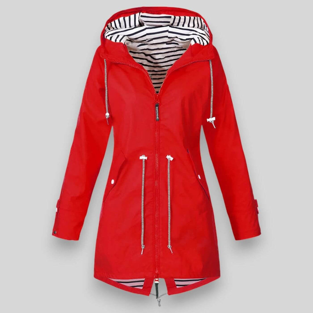 Woman in a yellow waterproof jacket walking outdoors in light rain