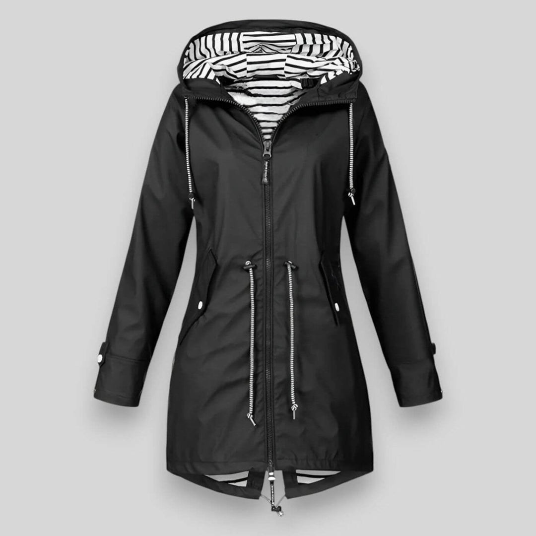 Flat lay of a black waterproof jacket showing lightweight construction and clean silhouette