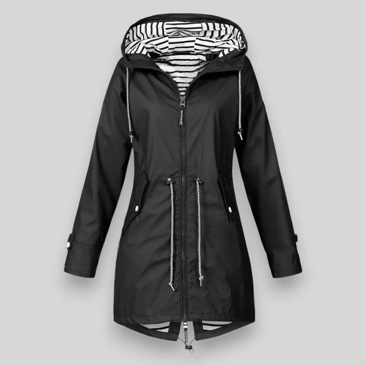 Flat lay of a black waterproof jacket showing lightweight construction and clean silhouette