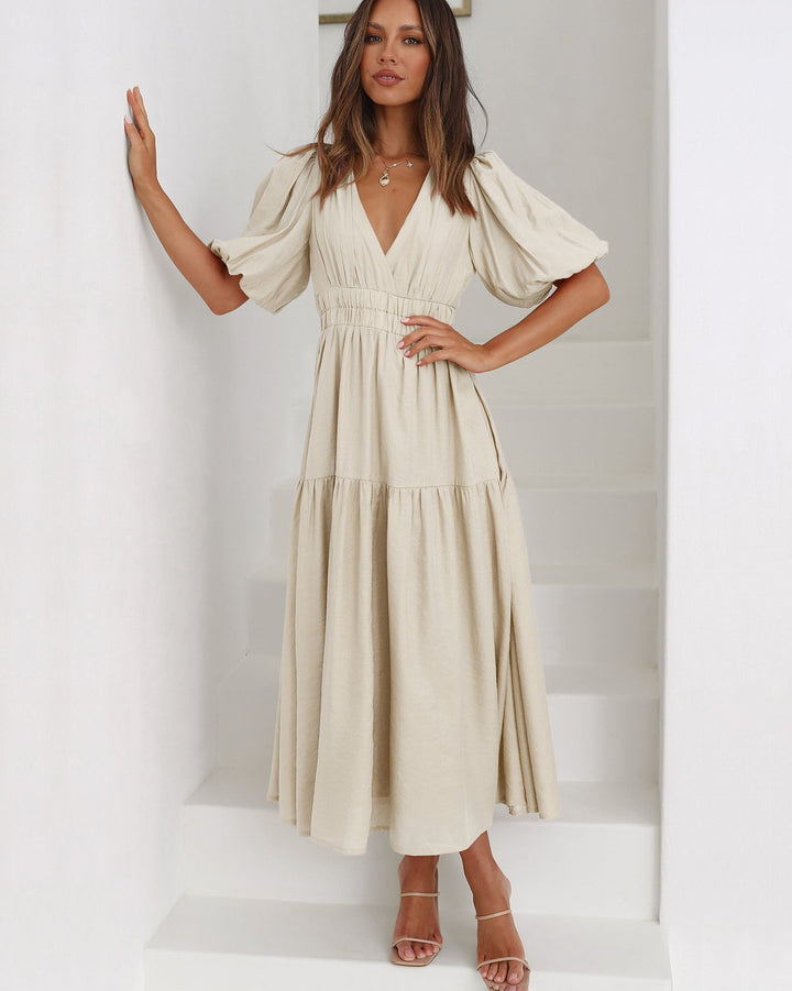 Noelle black midi dress side profile showing puff sleeve and midi hem length