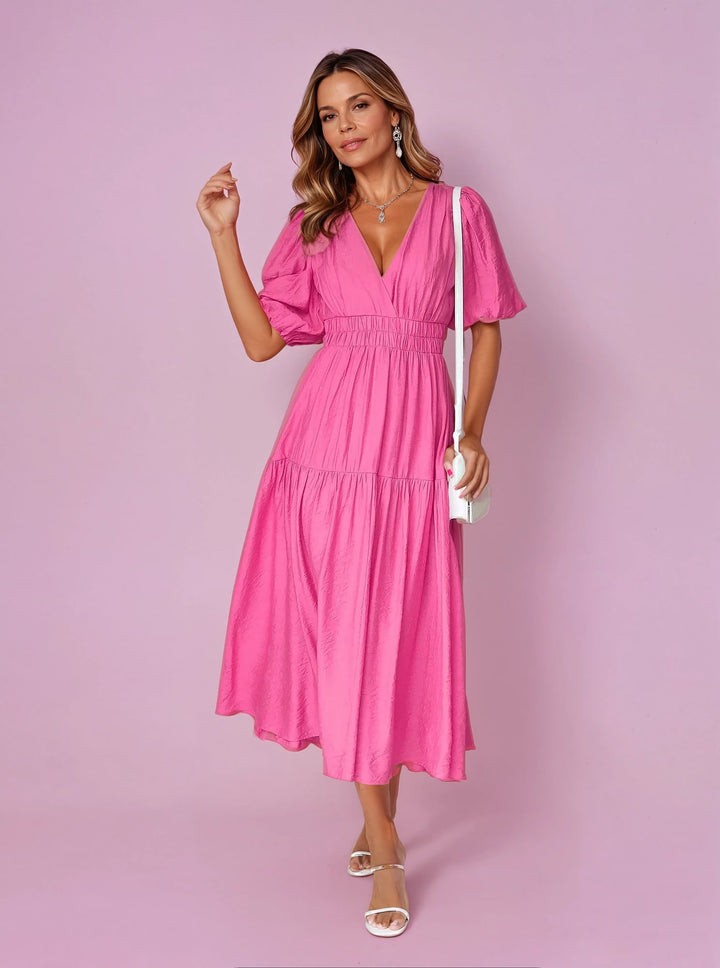 Noelle pink midi dress showing deep V-neckline and voluminous puff sleeves
