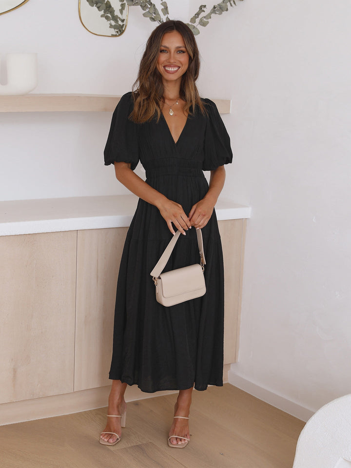 Noelle pink midi dress side view highlighting smocked waist and full skirt