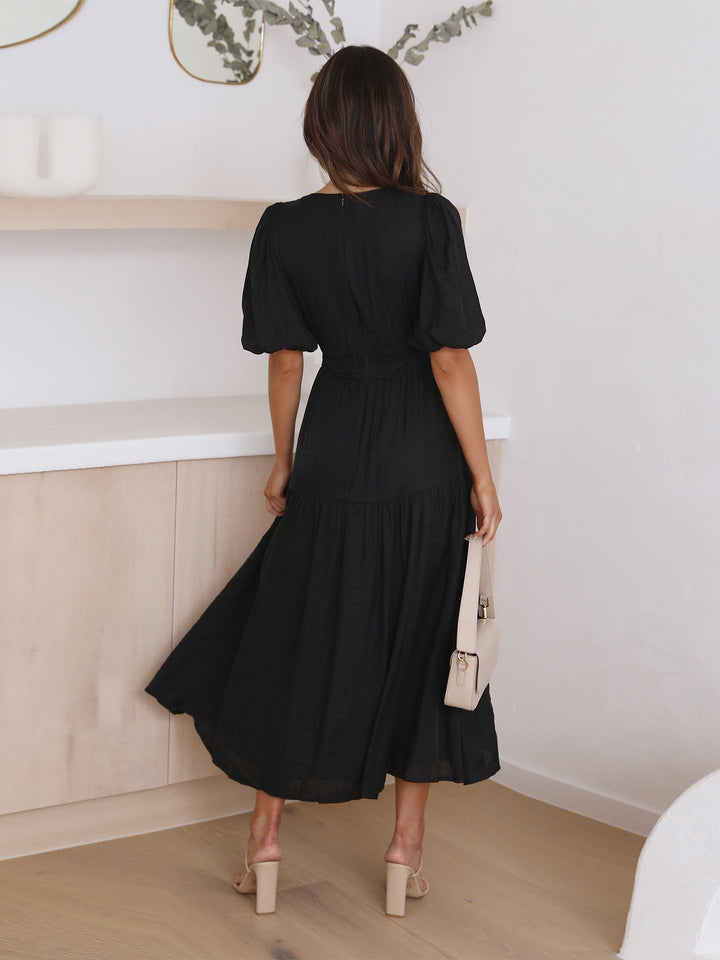 Noelle cream midi dress three-quarter view showing flowing midi skirt