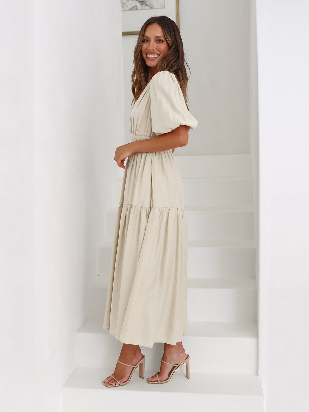 Noelle white midi dress side view highlighting puff sleeves and midi length